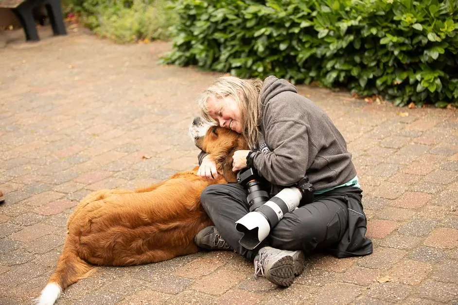 Elaine smiling with a dog named Annie