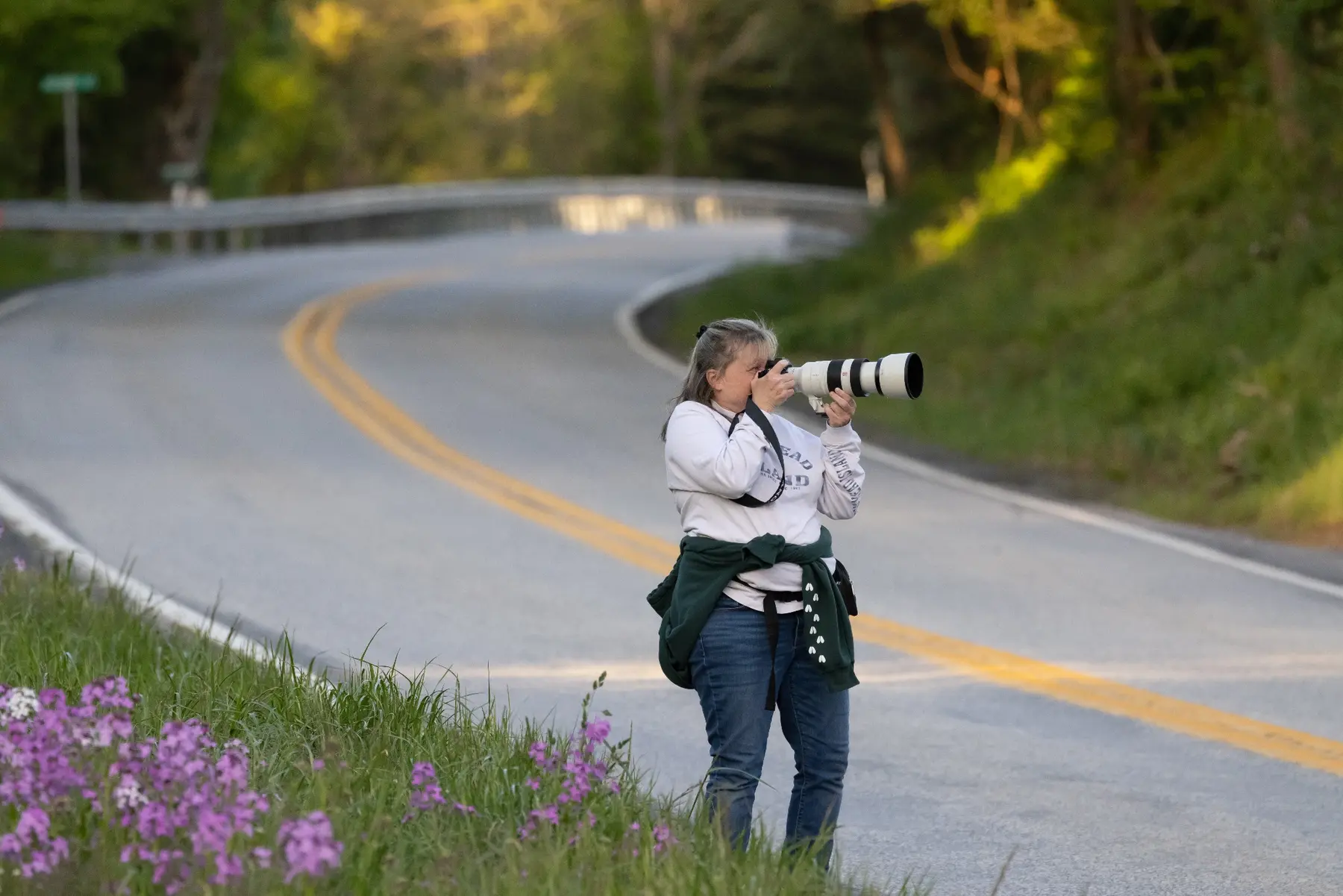 Elaine photographing outdoors with a long lens